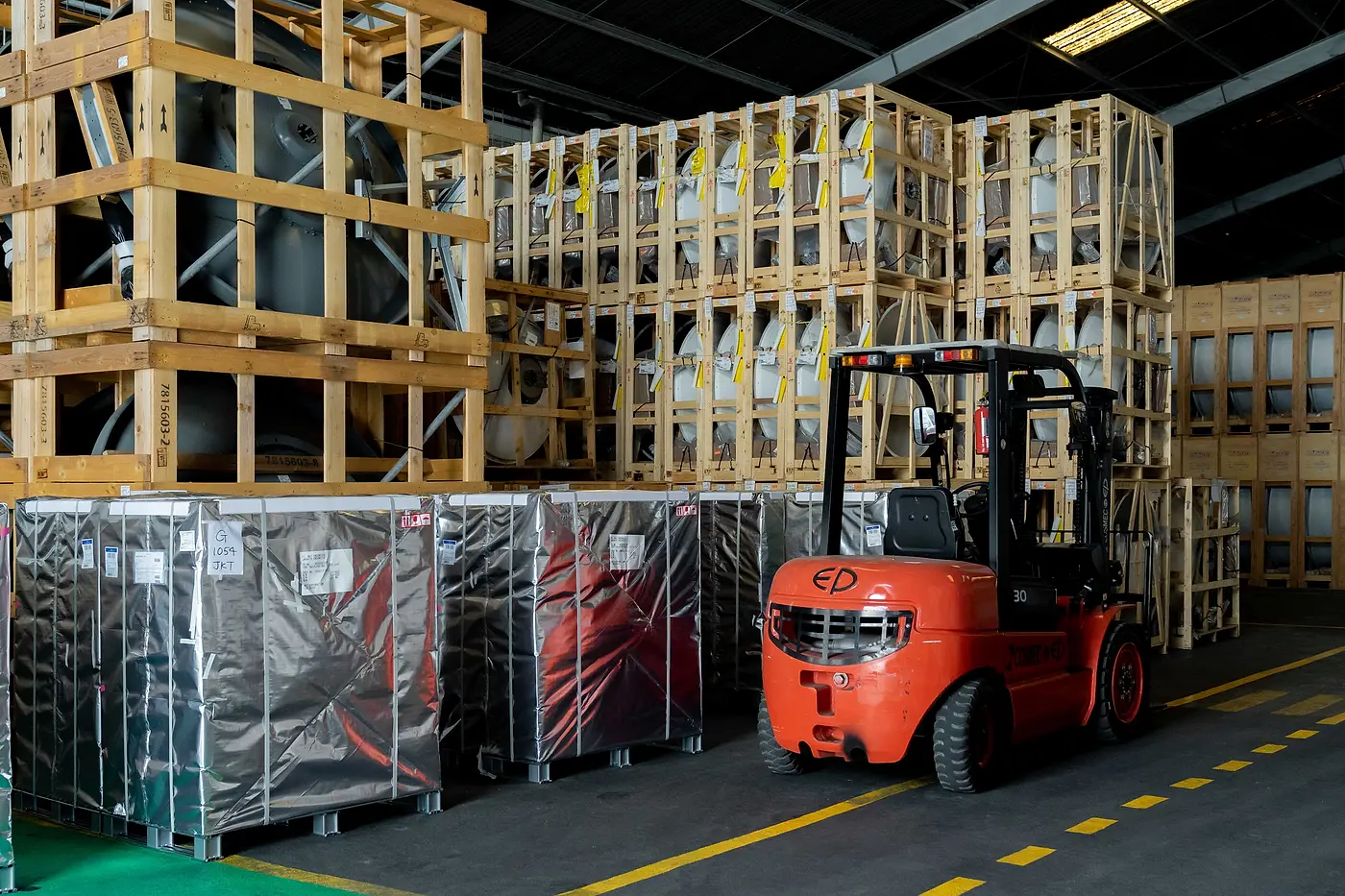 A forklift moving wrapped cargo in the DMM warehouse
