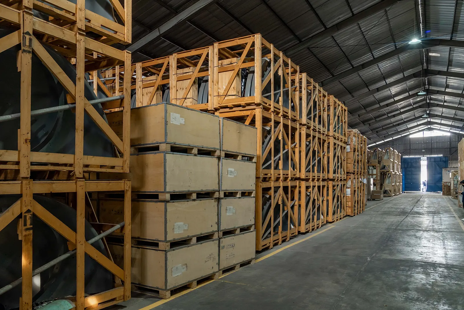 Timber crates racked several levels high in the DMM warehouse